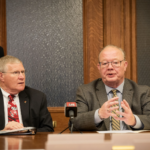 Howard Marklein and Todd Novak sitting at desk