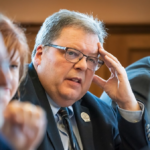 Pat Snyder resting his head on his hand