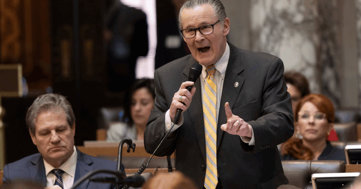 wisconsin republican bob donovan speaking into a microphone while pointing with his finger