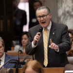 wisconsin republican bob donovan speaking into a microphone while pointing with his finger