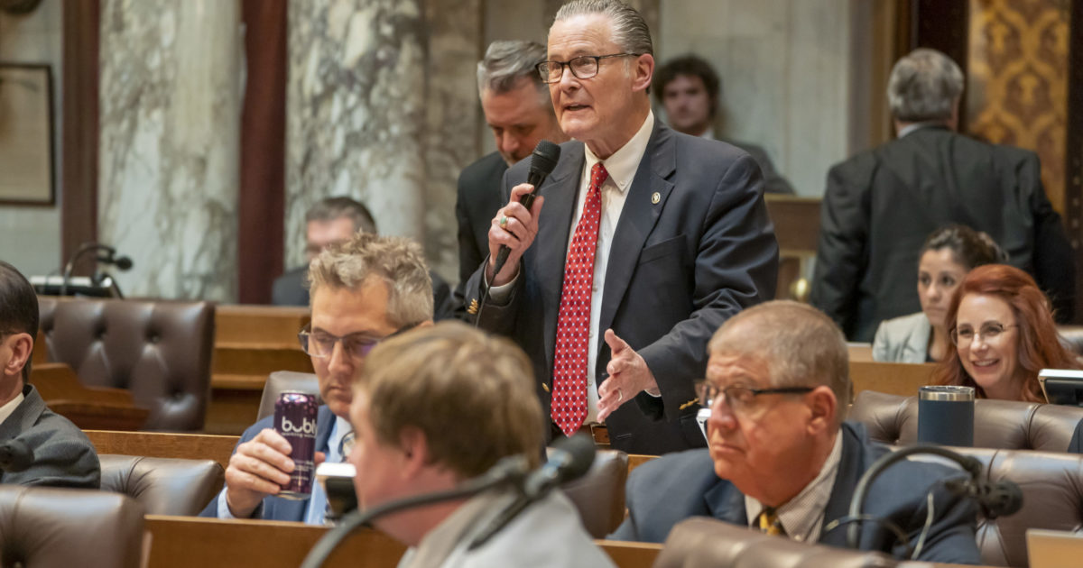 Wisconsin State Rep. Bob Donovan standing, speaking into a microphone