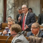 Wisconsin State Rep. Bob Donovan standing, speaking into a microphone