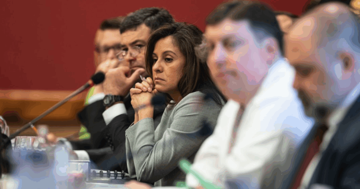 Wisconsin Republican Jessie Rodriguez sitting a table among other public officials