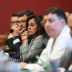 Wisconsin Republican Jessie Rodriguez sitting a table among other public officials