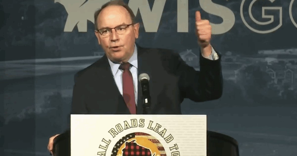 wisconsin republican tom tiffany at a podium with his thumb in the air