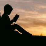 silhouette of child student reading school book