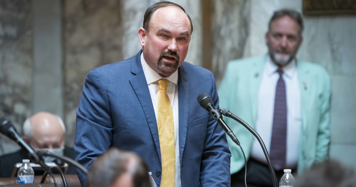 Rep. Clint Moses speaking into microphone