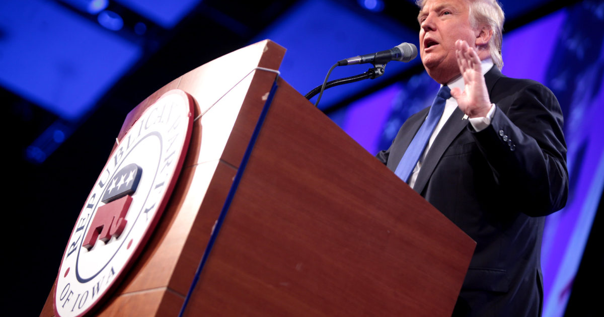 Donald Trump speaking at a podium