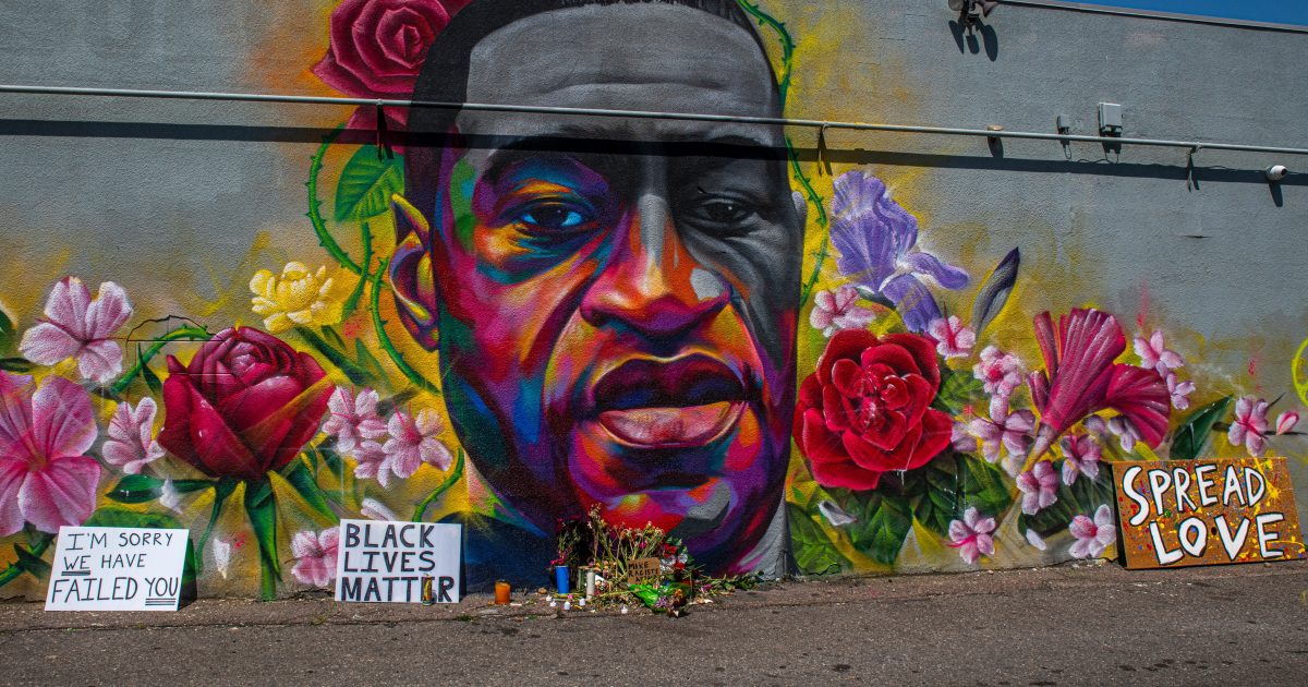 mural depicting george floyd portrait with flowers