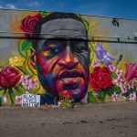 mural depicting george floyd portrait with flowers