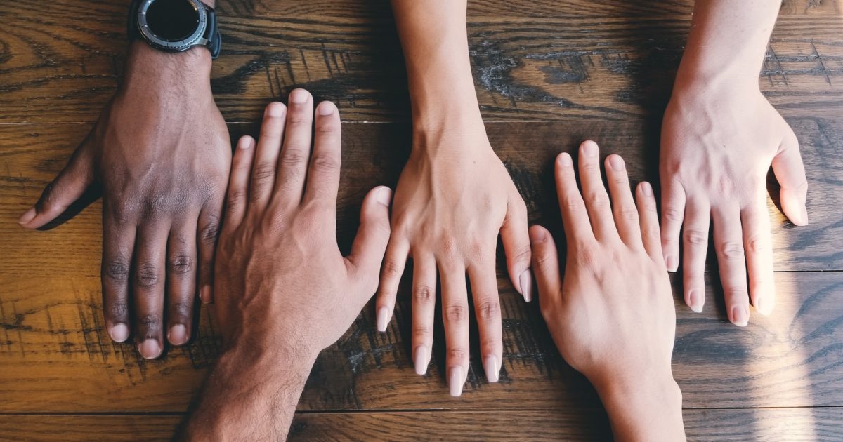 several hands coming together