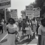 Black Americans marching during the Civil Rights era.
