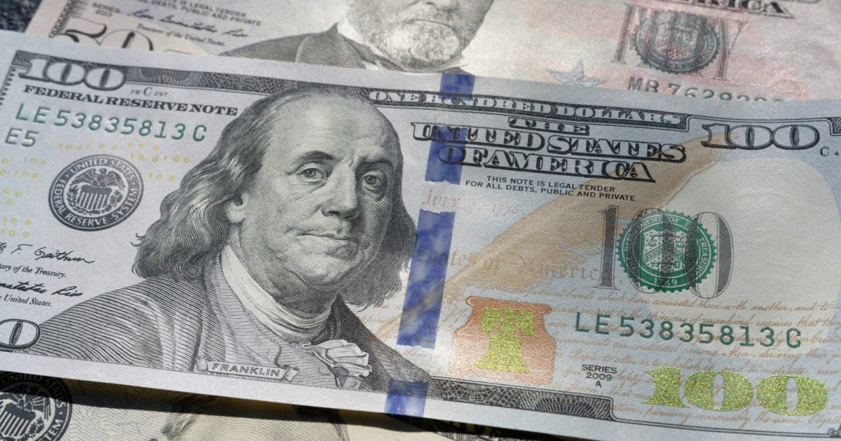 closeup on $100 bill with $50 bills