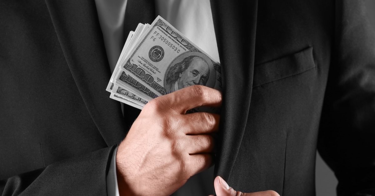 Man with money on dark background, closeup