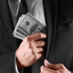 Man with money on dark background, closeup